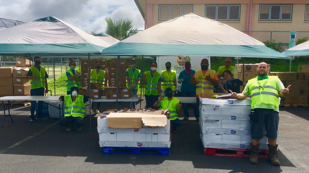 Volunteers at the Keaau Food Drive donating milk, eggs, and other food items