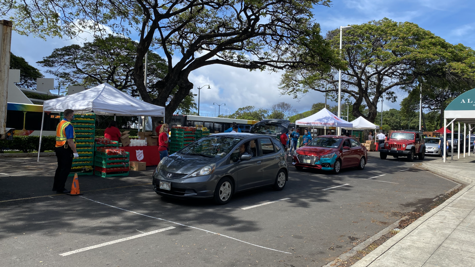 Servicing eight cars at a time, volunteers placed food into each car