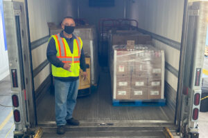 Driver posing with cargo in cargo truck