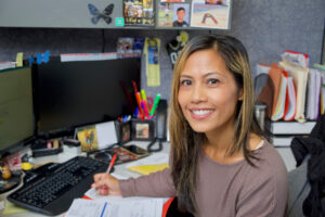 Woman smiling at her desk