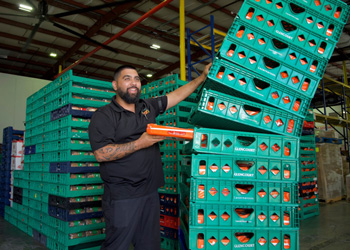 staff with stacks of large green trays